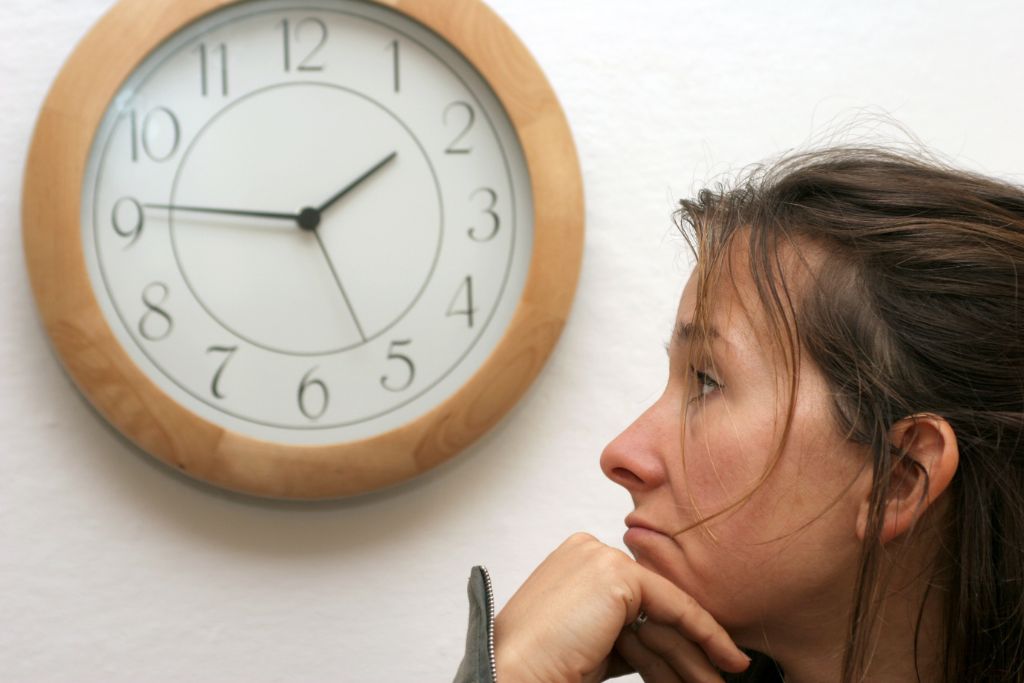 A person looking at the clock