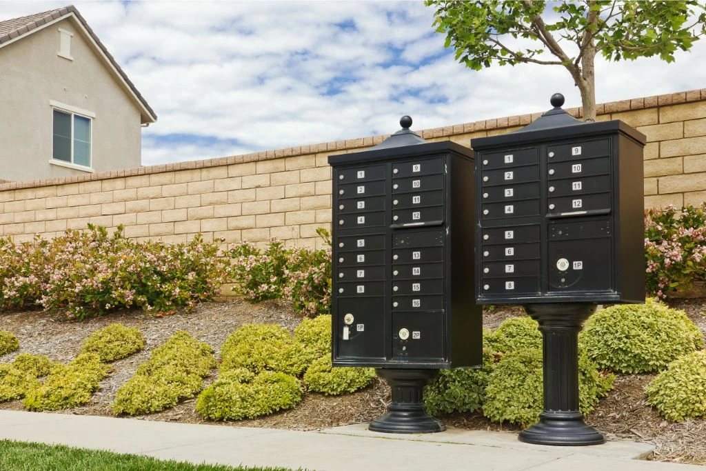 two big mailboxes outside of a house