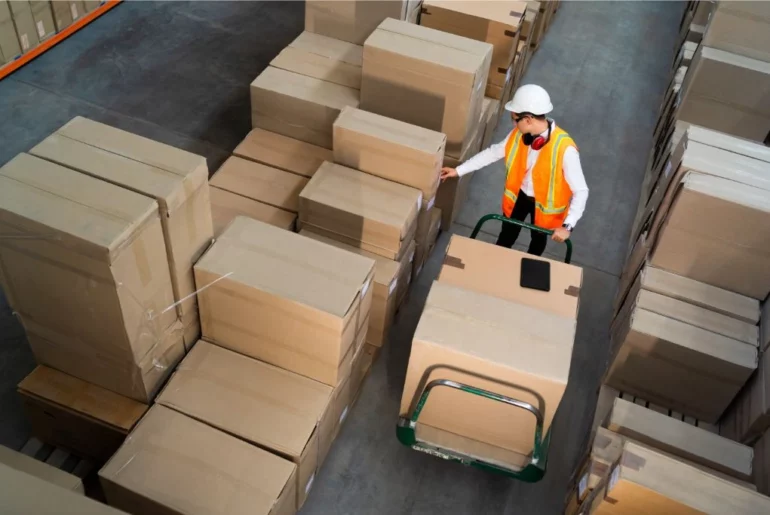 man arranging big packages inside the warehouse