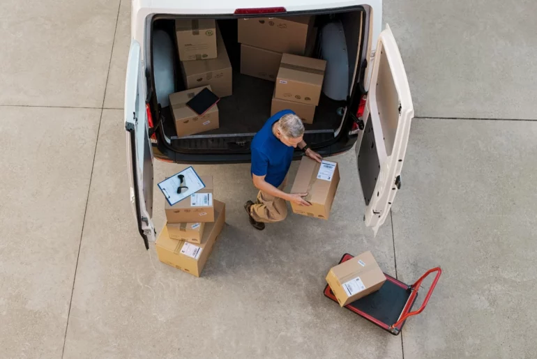 man unloading packages from the delivery car