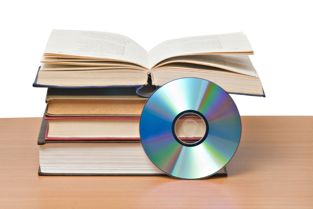 books stacked together with a CD
