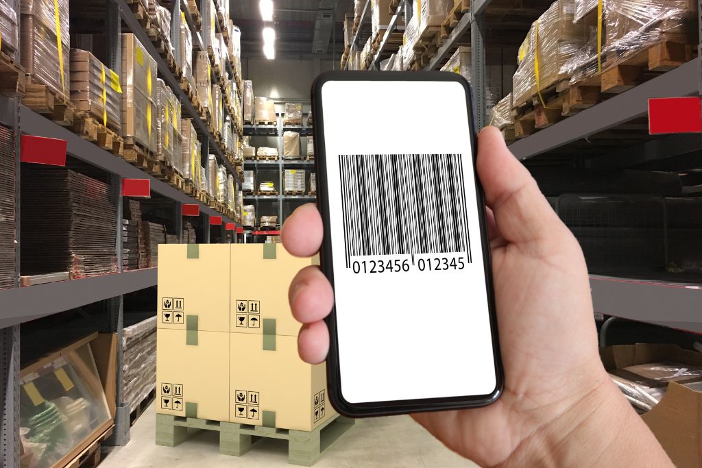 hand model with phone showing a barcode