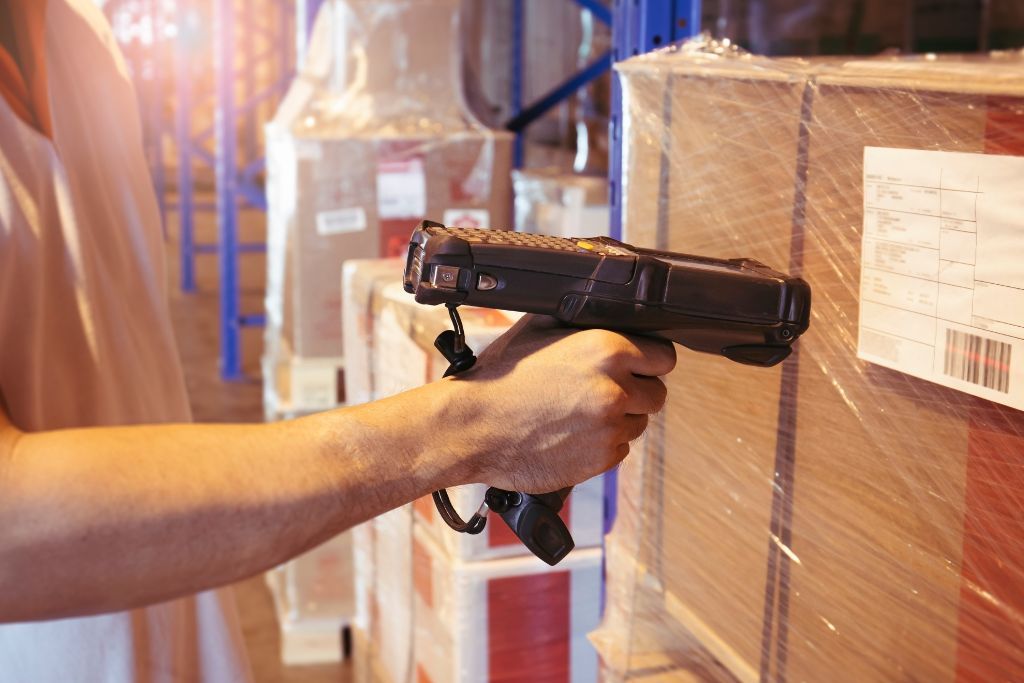 delivery facility employee scanning packages